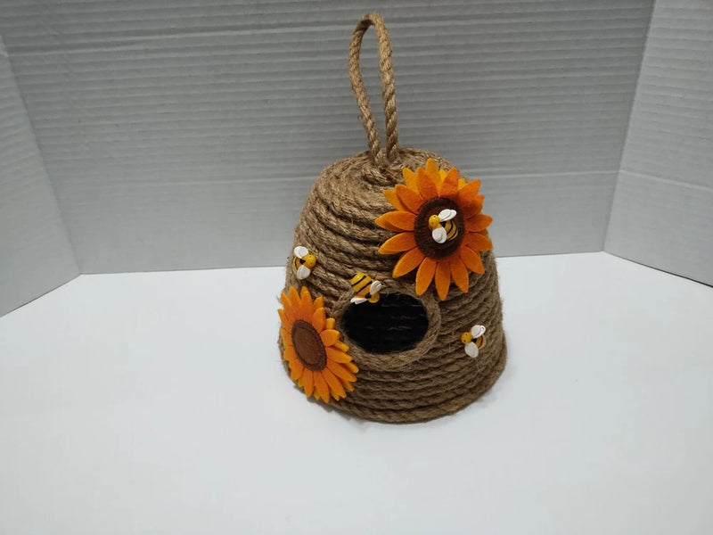 Burlap hanging decor pouch with rope loop, dark opening, and two orange sunflower flowers
