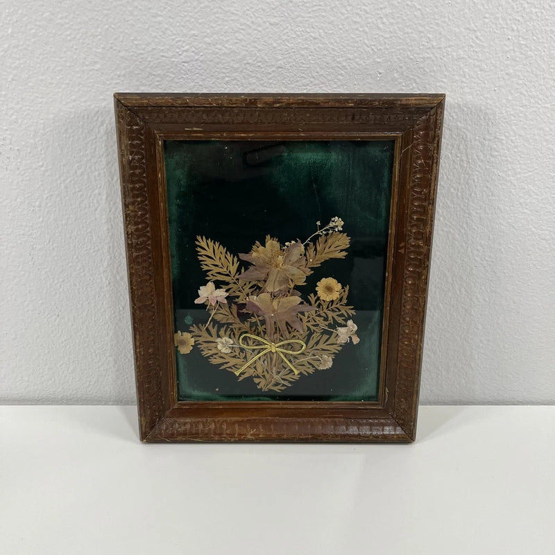 Vintage wood-framed pressed flower art with beige blooms under glass