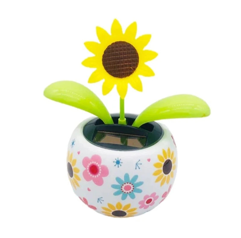 Solar sunflower toy in decorated pot with panel and green leaves
