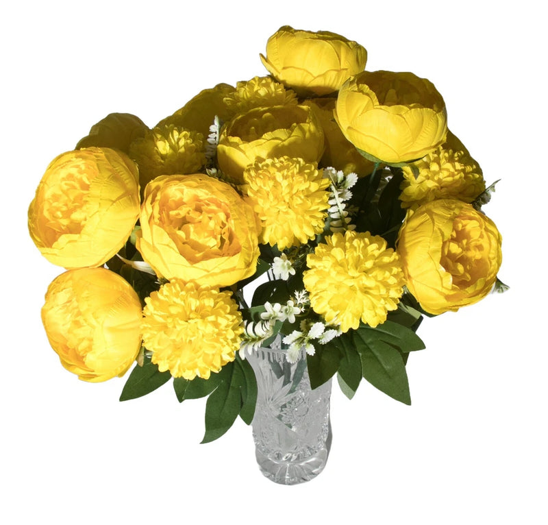 Artificial yellow peony bouquet with green leaves, white filler flowers, and clear vase