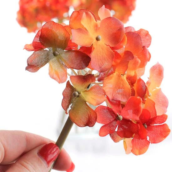 Artificial silk hydrangea floral stems bouquet with orange and red clustered blooms