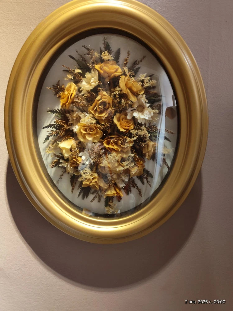 Oval convex framed dried flower arrangement with roses and herbs