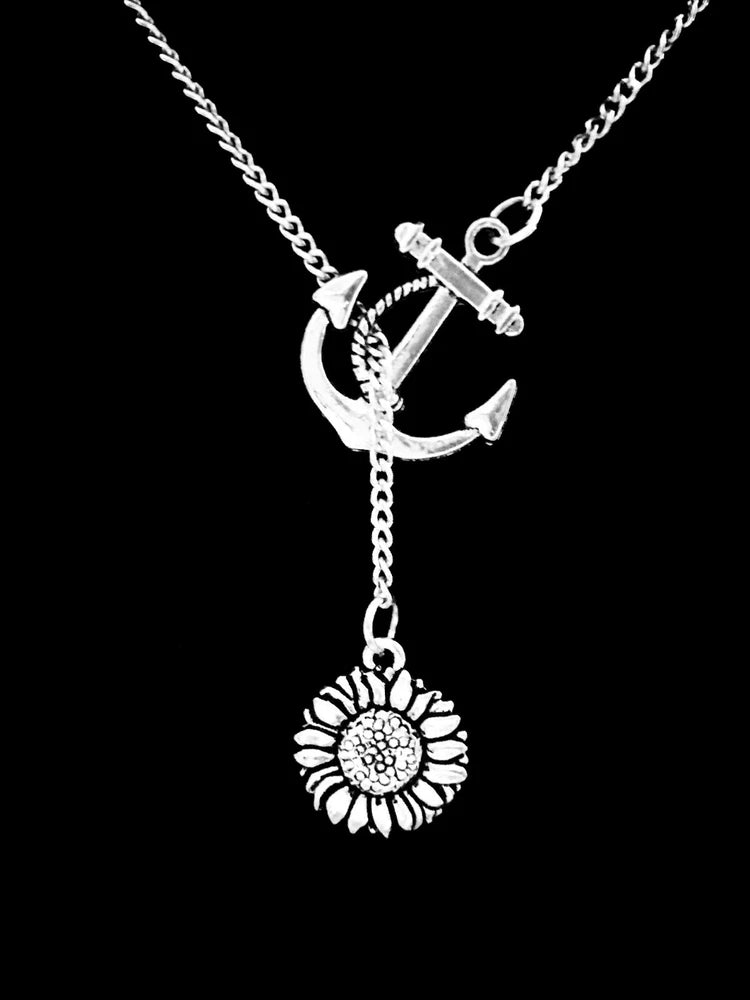Silver lariat necklace with anchor charm and dangling sunflower flower pendant