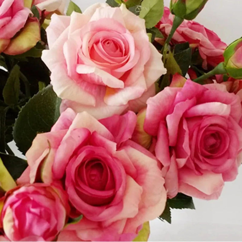 Artificial pink rose wedding bouquet with layered blooms and green leaves