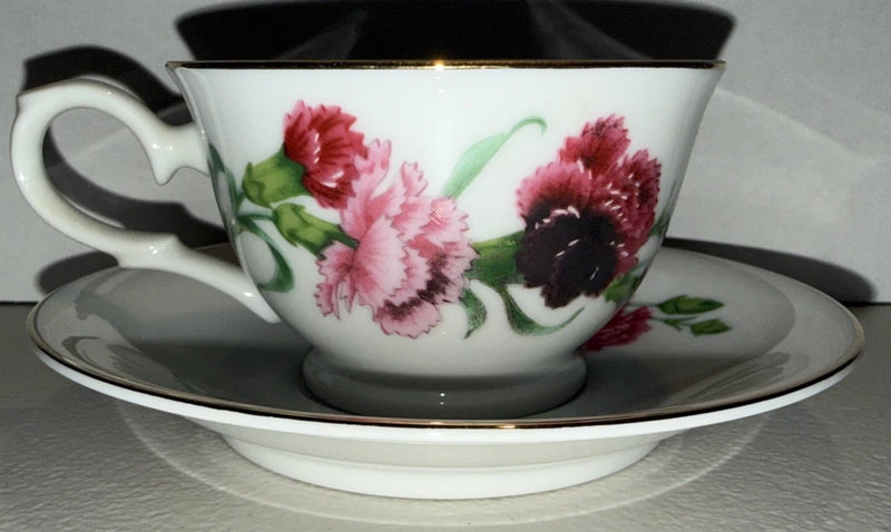 Avon floral teacup and saucer set, white with pink and red carnation flowers