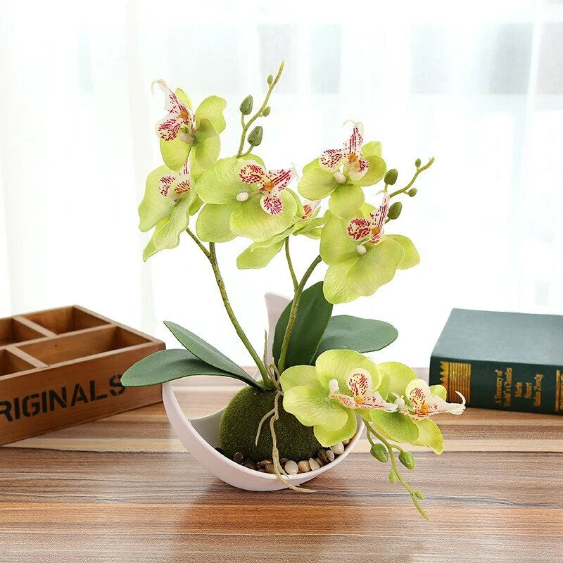 Artificial orchid bonsai flower arrangement in white pot with green leaves and pink-speckle blooms