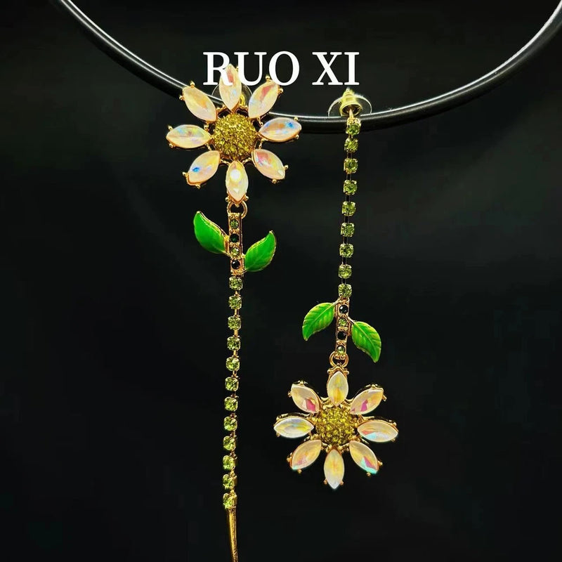 Enamel sunflower tassel earrings with long green crystal strands and dangling flower leaves