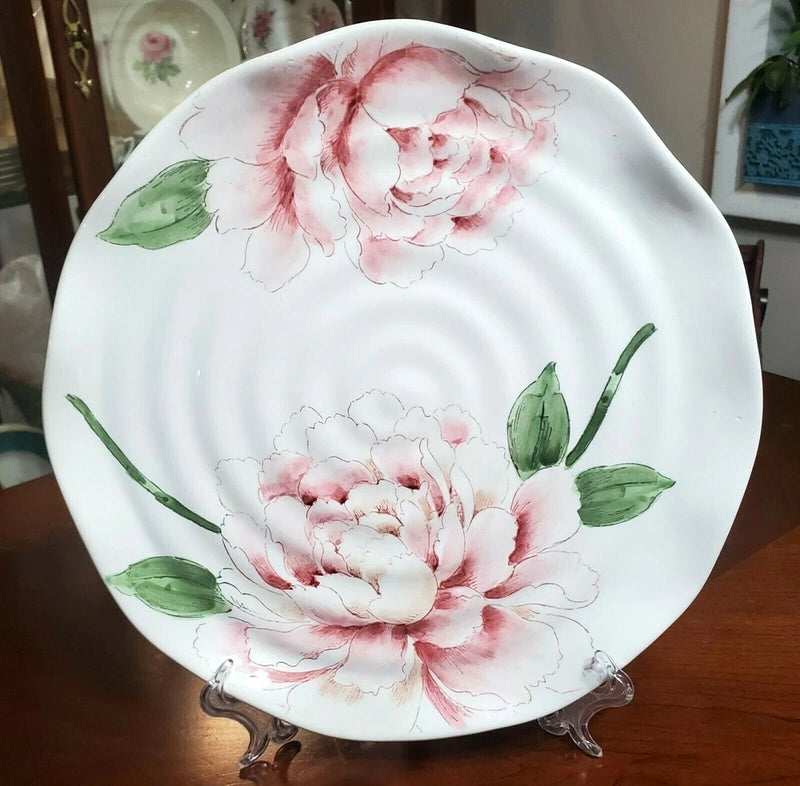 Hand-painted white dinner plate with pink peonies and green leaves, scalloped rim