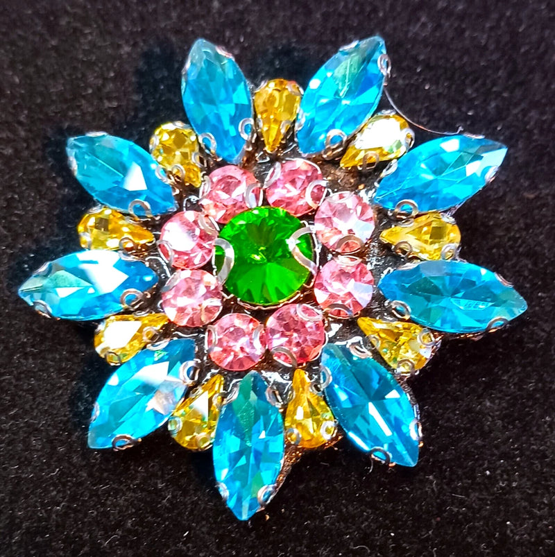 Colorful rhinestone flower brooch with blue, pink, yellow petals and green center