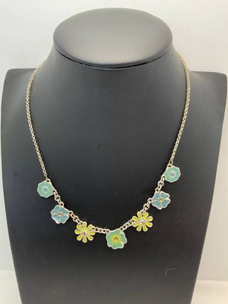 Gold-tone floral daisy necklace with small blue, green, and yellow enamel charms