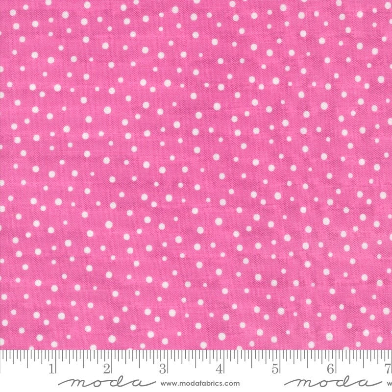 Pink cotton quilting fabric with small white dot pattern and inch ruler scale