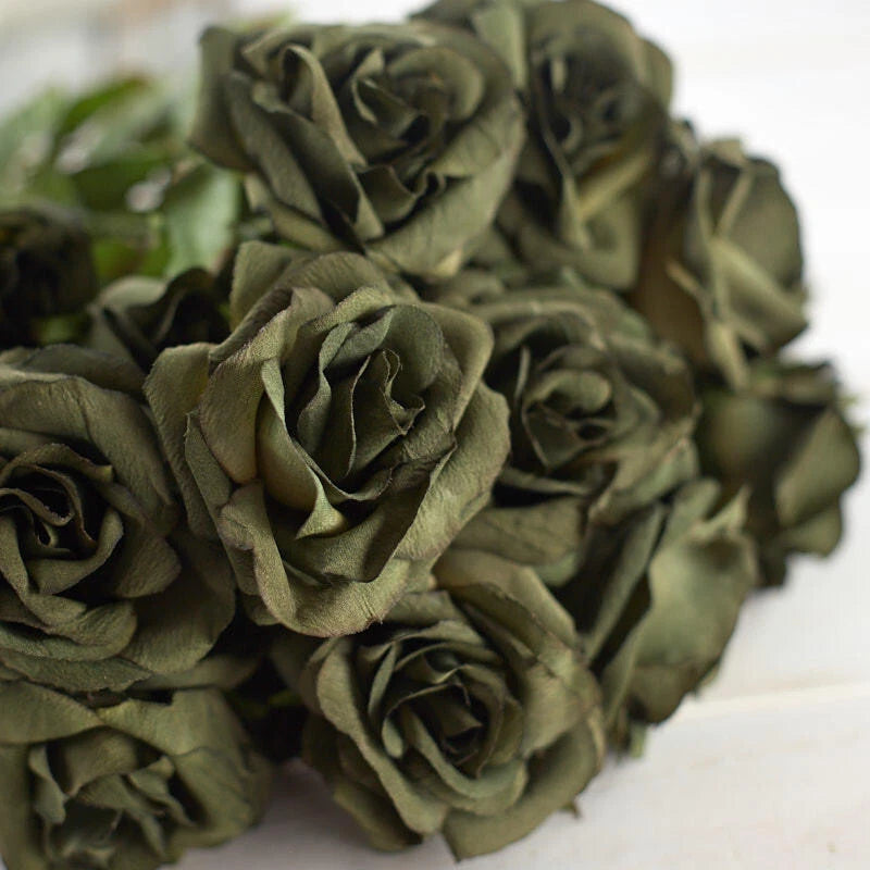 Sage green artificial rose heads with layered petals, floral spray close-up