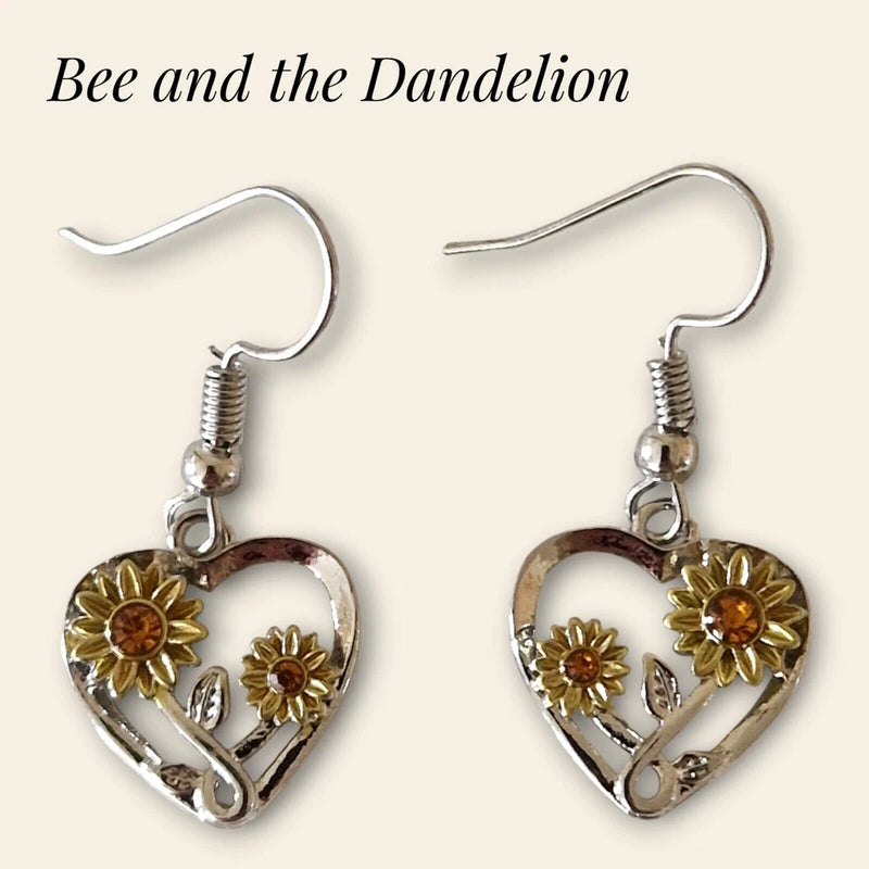Silver-tone heart earrings with sunflower charms and orange centers, fishhook backs