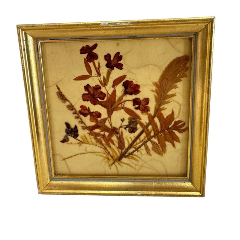 Gold framed dried flower artwork with burgundy botanical stems and leaves