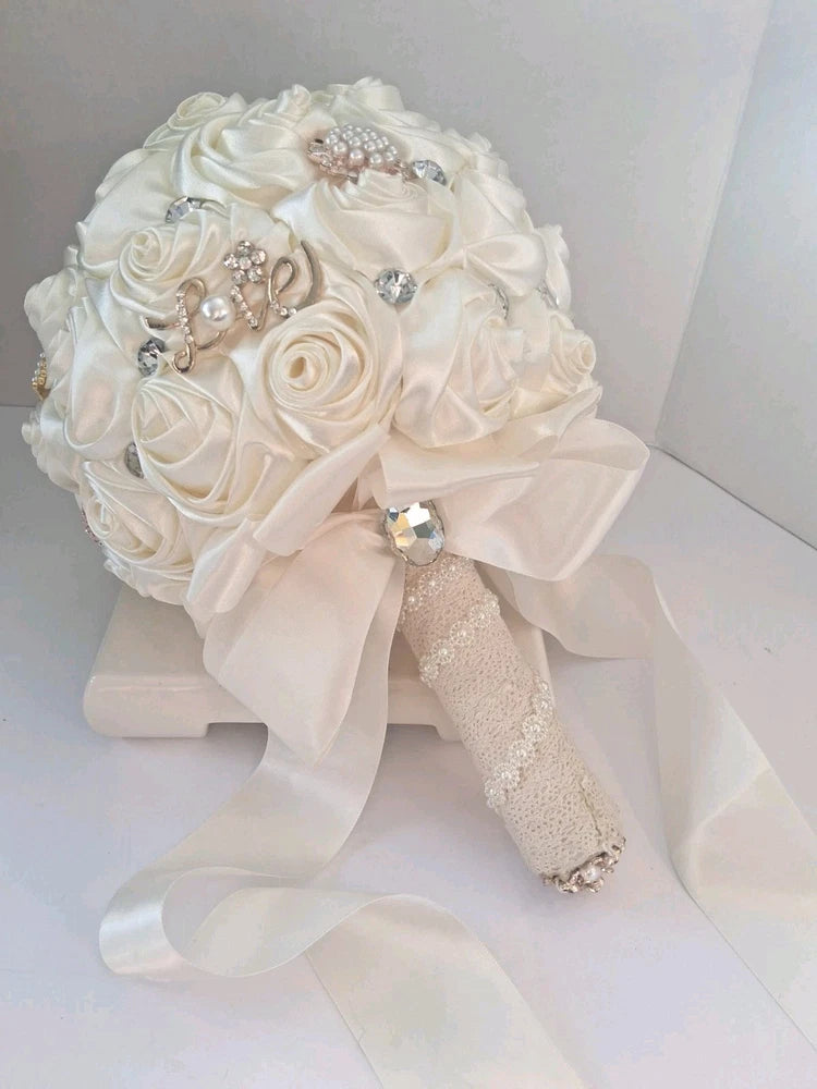 Ivory cream satin rose bridal bouquet with diamante brooch accents and ribbon handle