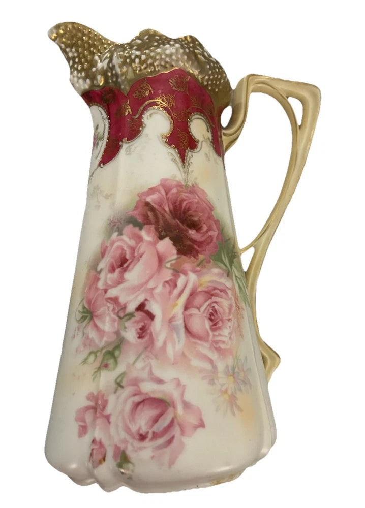 Pink floral porcelain pitcher with gold trim and curved handle, vintage style