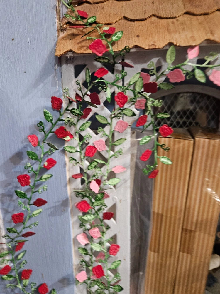 Mini bendable rose vine garland with red and pink flowers and green leaves