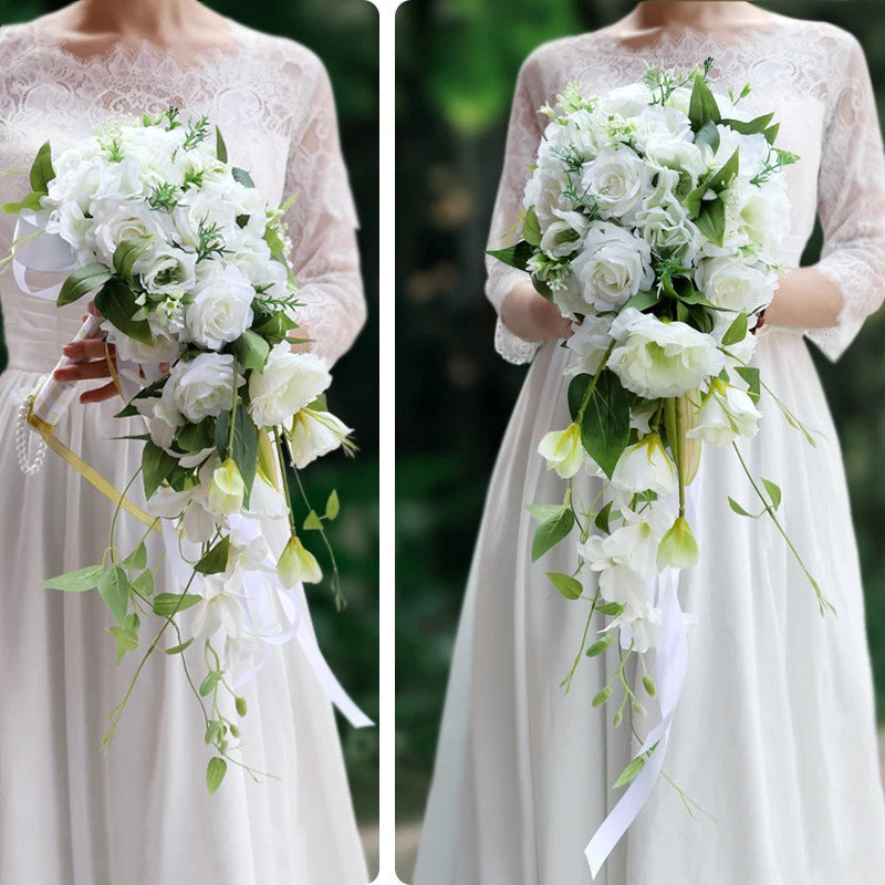 Simulated rose wedding bouquet with white blooms, green leaves, and long hanging ribbon