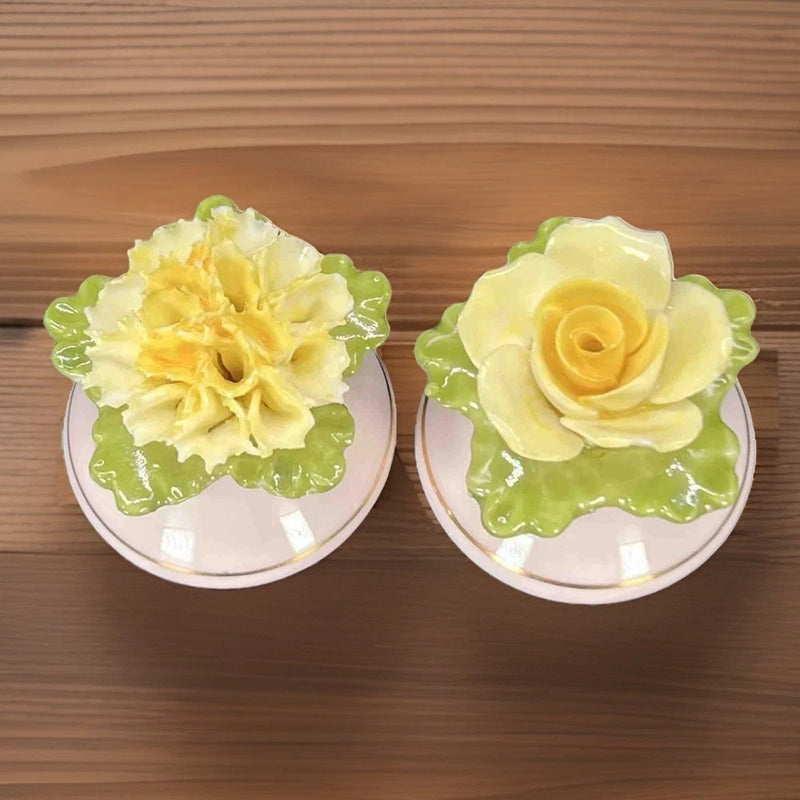 Vintage floral ceramic salt and pepper shakers with yellow flower tops and green leaves