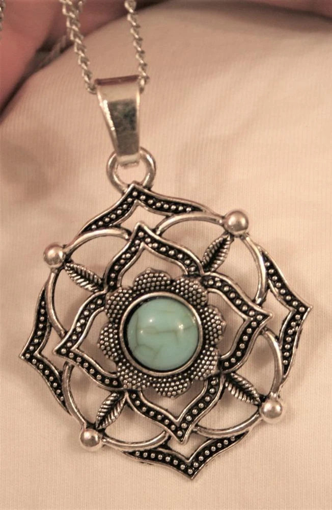 Silvertone openwork sunflower pendant necklace with turquoise teardrop center