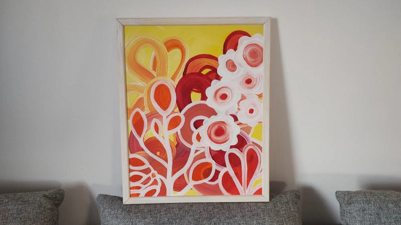 Acrylic floral picture with swirling red, white, and yellow shapes in a frame