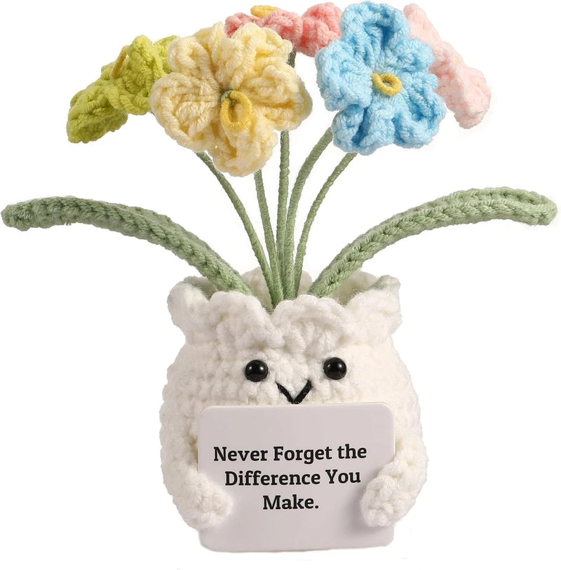Crochet potted plant with smiling face pot and three pastel yarn flowers on stems