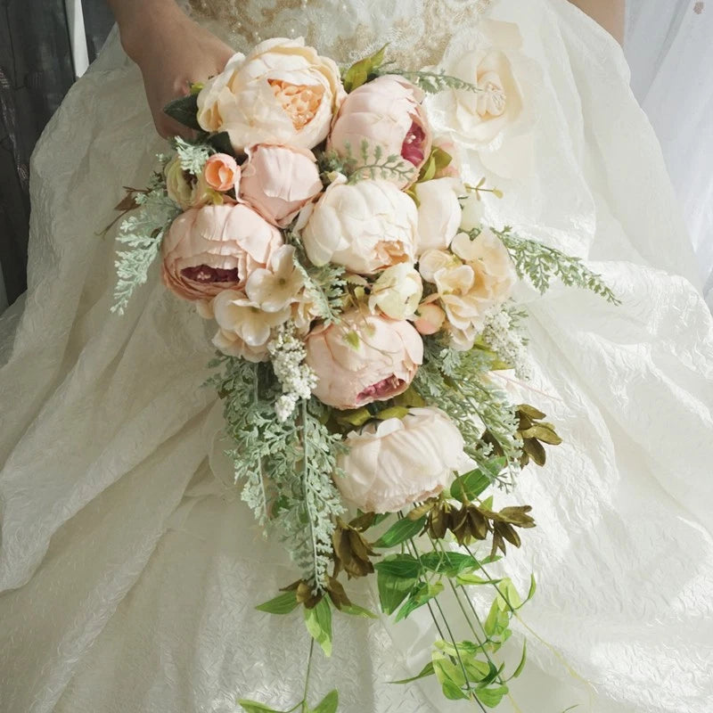 Bridal waterfall flower bouquet with cream, pink and champagne blooms and leafy greenery