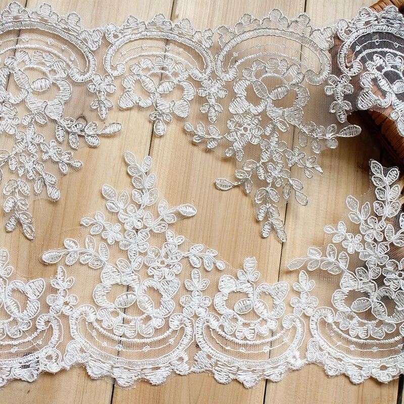 White embroidered sequin lace trim with floral rosette motifs and scalloped edge