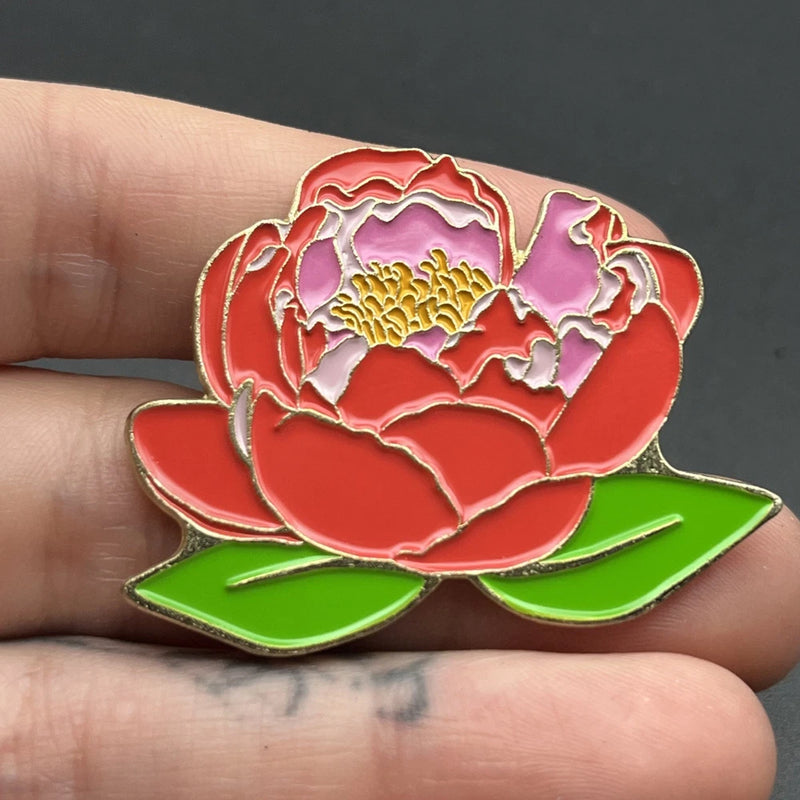 Peony flower enamel lapel pin with red and pink petals and yellow center