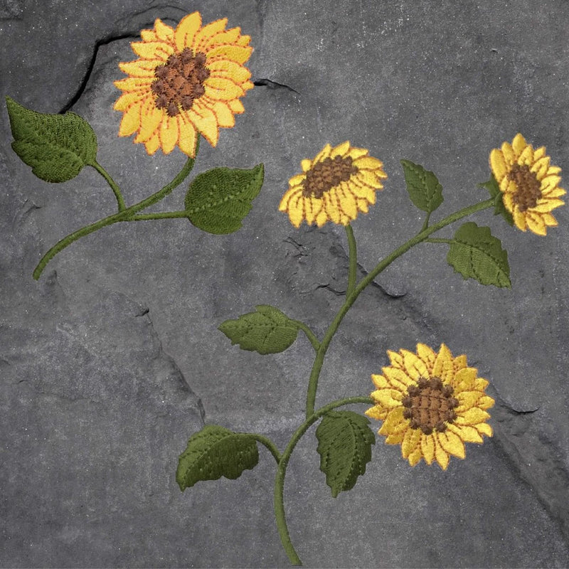 Sunflower applique patch set with four yellow blooms, green stems, and leaves