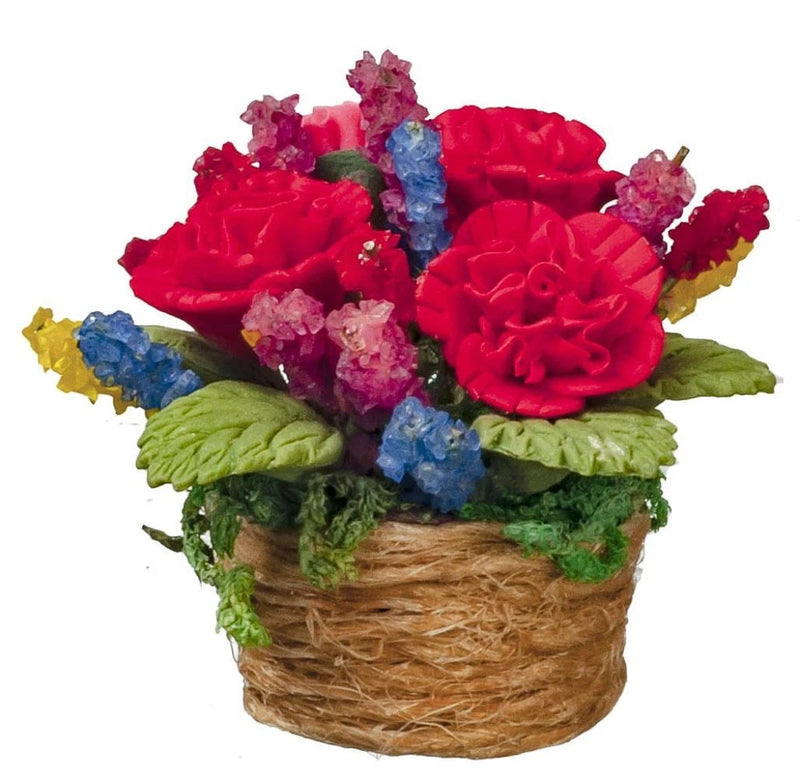 Miniature rope basket house plant with red carnations, pink blooms, blue accents, green leaves