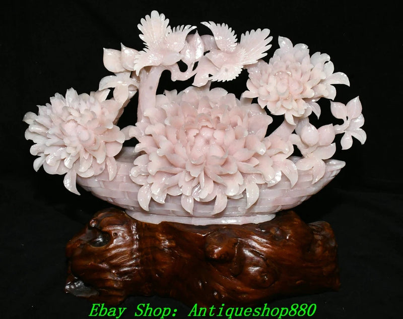 Pink carved jade peony flower bird basket statue with layered blossoms and dark wooden base