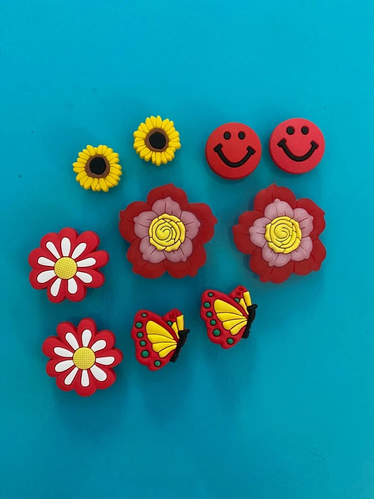 Colorful shoe charms set with smiley faces, sunflowers, ladybugs, and flower shapes
