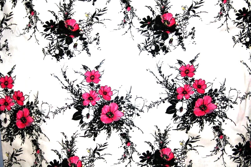 White cotton fabric with pink and black floral bouquet pattern with leafy accents