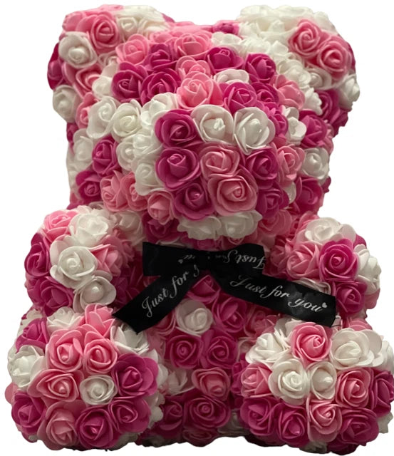 Artificial rose teddy bear with pink and white rosette flowers, black ribbon