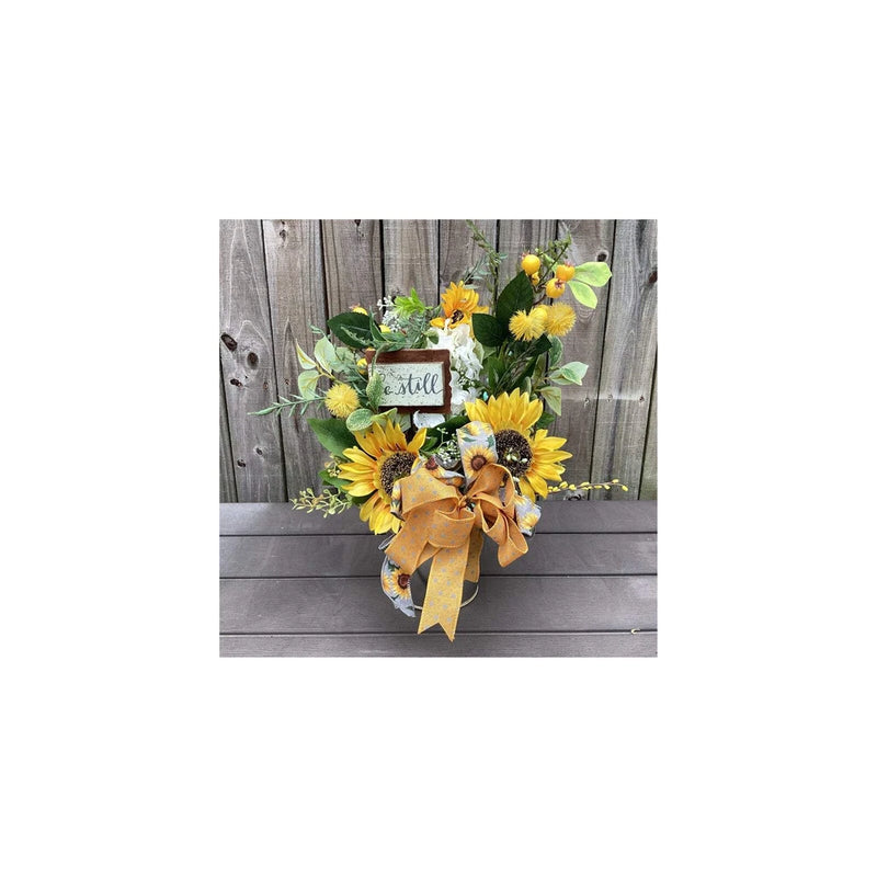 Galvanized metal sunflower display with yellow blooms, bow ribbon, and small tag
