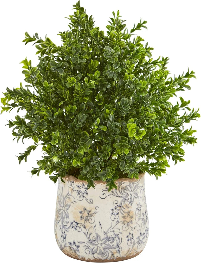 Artificial sweet grass plant in decorative floral vase, green leaves in white ceramic pot
