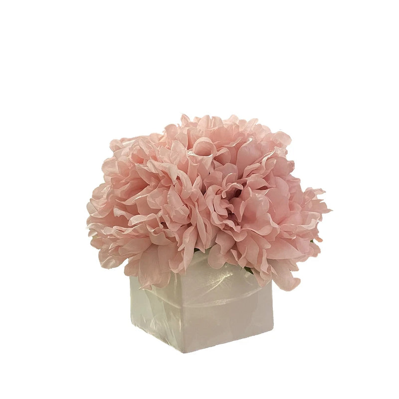 Artificial pink peony flowers in square white vase, faux flower arrangement