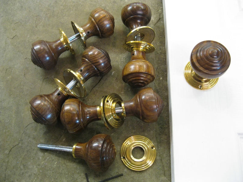 Rosewood reeded door knobs set with brass backplates and mounting hardware