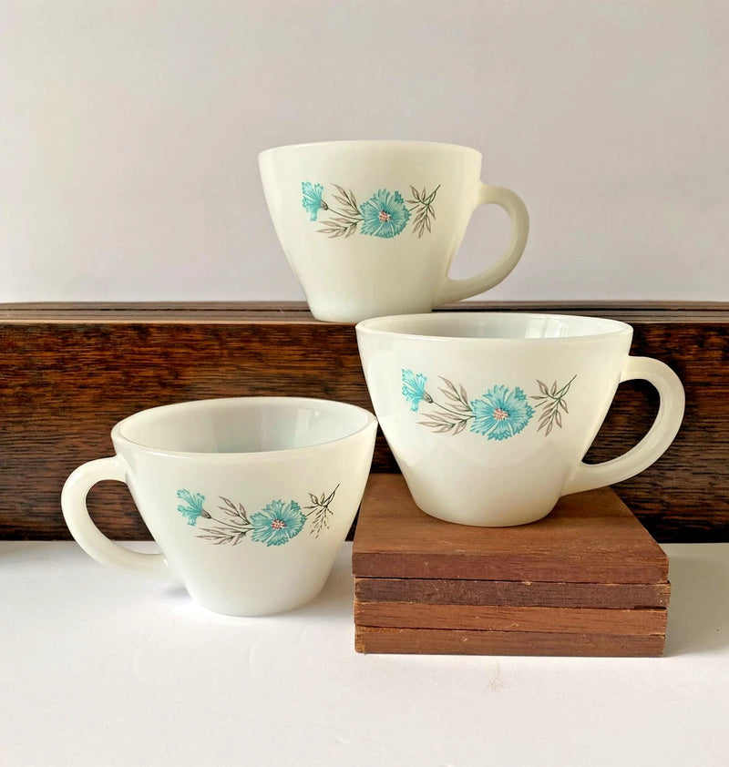 Set of 3 white milk glass teacups with blue floral print and curved handles