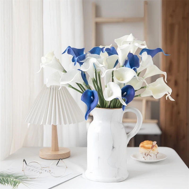 Set of faux calla lily flowers, white and blue, in a white vase arrangement