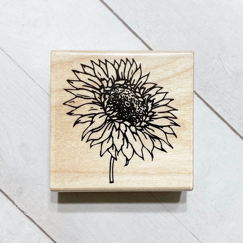 Wood-mounted sunflower craft stamp on square wooden block with black flower outline
