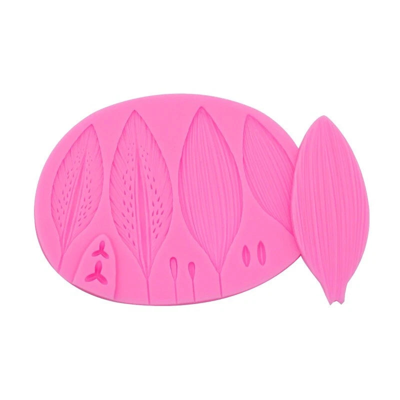 Pink silicone lily petal and leaf fondant mold with molded flower and leaf shapes
