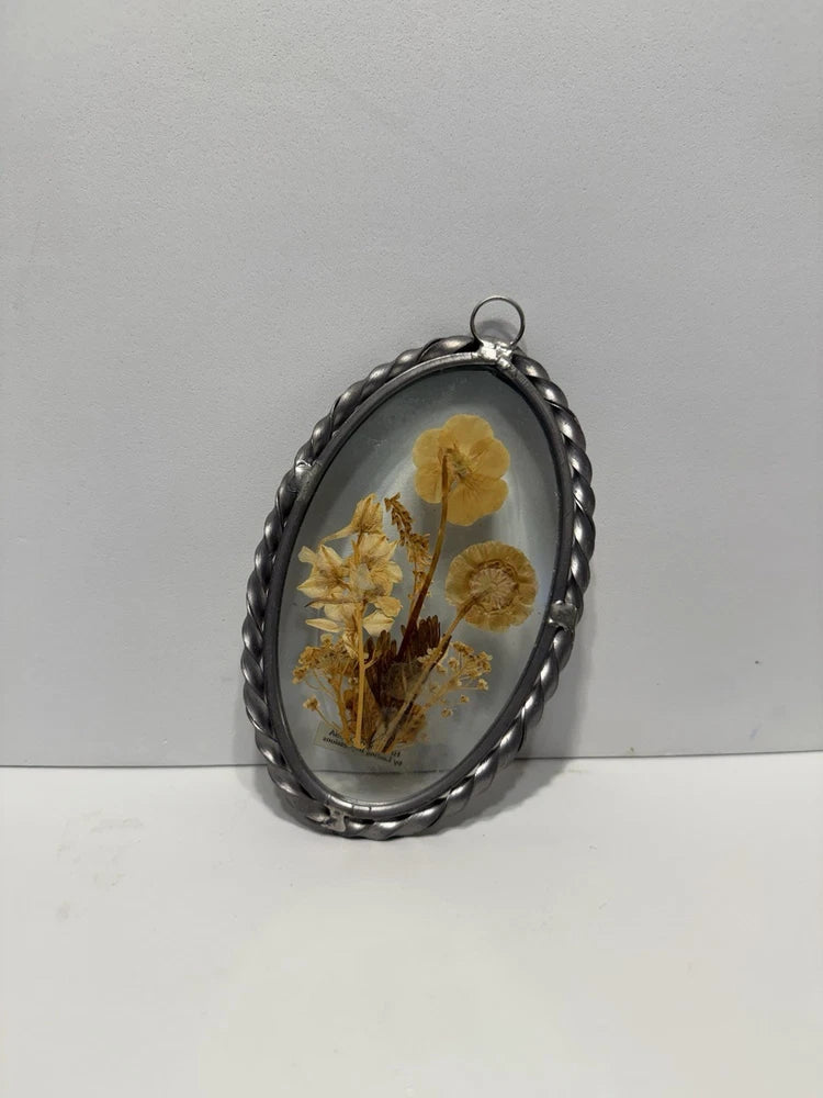 Oval glass frame with pressed dried flowers in silver metal, with hanging loop