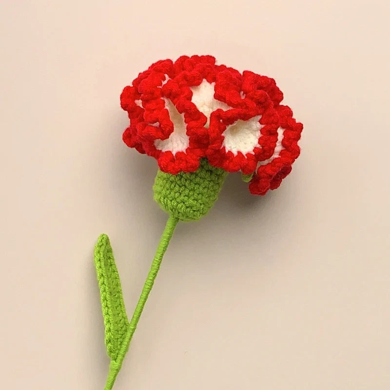 Artificial crochet carnation flower with red blooms and green stem and leaves