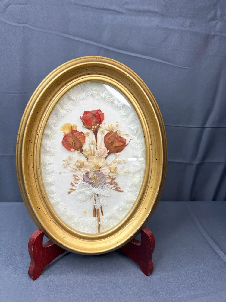 Gold oval wood frame dried flower pressed art with bouquet on off-white background