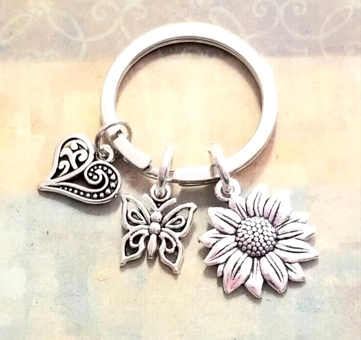 Silver-tone key ring with sunflower and butterfly charms