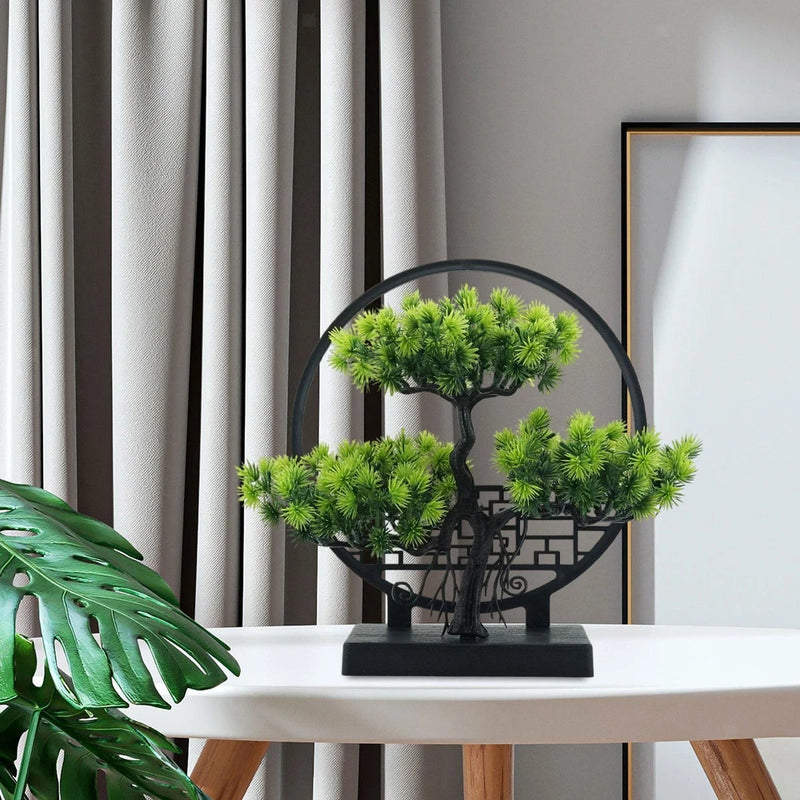 Small artificial bonsai tree with dark trunk and bright green clustered leaves in black pot