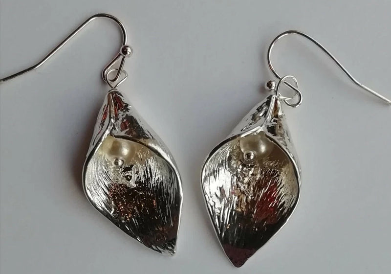 Silver-tone drop earrings with teardrop floral cap and small pearl bead
