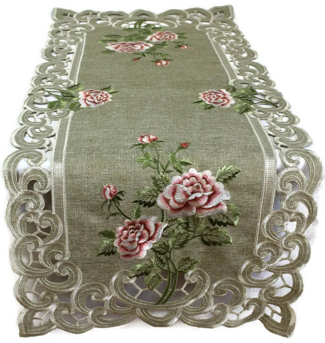 Green burlap table runner with embroidered pink roses and scalloped lace border